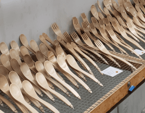 Apply protective coatings to wooden utensils
